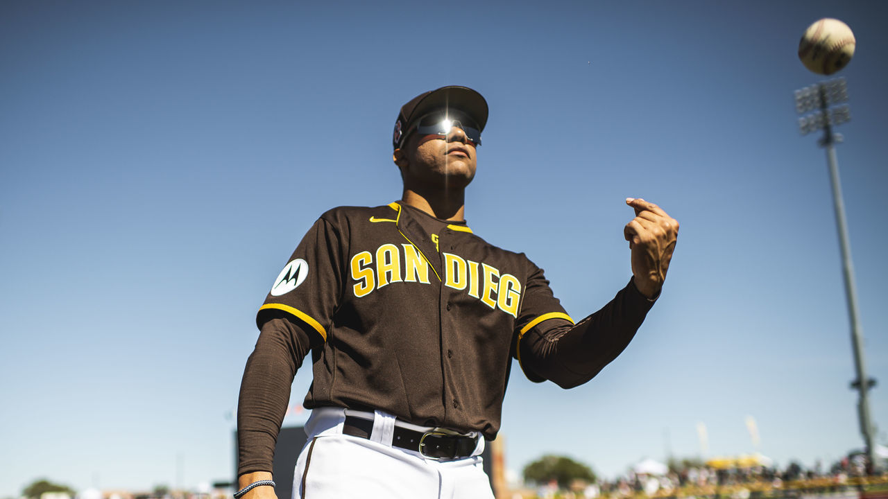 PEORIA, AZ - FEBRUARY 24: Juan Soto #22 of the San Diego Padres flips a ball to a fan before a spring training game against the Seattle Mariners at Peoria Stadium on February 24, 2023 in Peoria, Arizona.