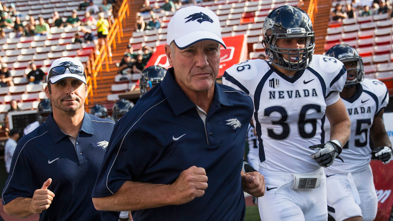 HONOLULU, HI - SEPTEMBER 22: Head Coach Chris Ault of the Nevada Wolfpack runs out onto the field before the start of a NCAA game against the Hawaii Warriors on September 22, 2012 at Aloha Stadium in Honolulu, Hawaii.