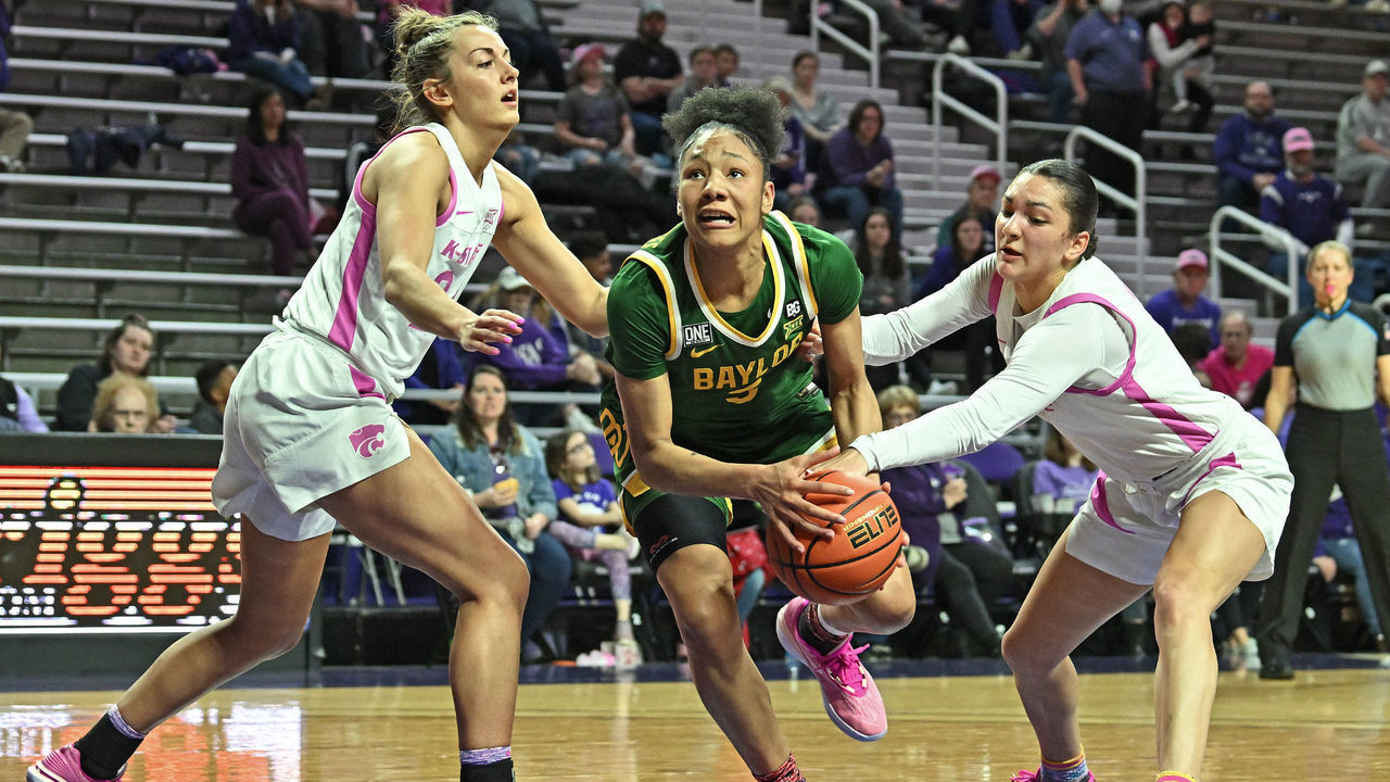 MANHATTAN, KS - FEBRUARY 15: Darianna Littlepage-Buggs #5 of the Baylor Bears drives to the basket between Emilee Ebert #24 and Jaelyn Glenn #3 of the Kansas State Wildcats, during a game in the first half at Bramlage Coliseum on February 15, 2023 in Manhattan, Kansas.