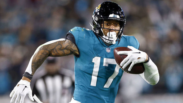 JACKSONVILLE, FLORIDA - JANUARY 14: Evan Engram #17 of the Jacksonville Jaguars carries the ball against the Los Angeles Chargers during the second half in the AFC Wild Card playoff game at TIAA Bank Field on January 14, 2023 in Jacksonville, Florida.