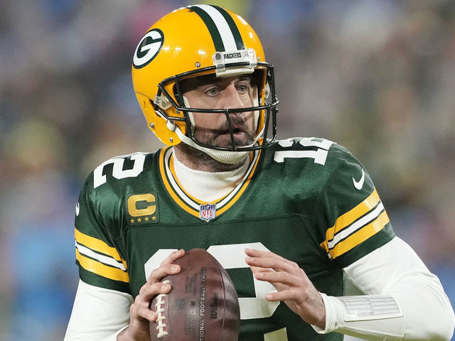 GREEN BAY, WISCONSIN - JANUARY 08: Aaron Rodgers #12 of the Green Bay Packers scrambles with the ball against the Detroit Lions in the first half at Lambeau Field on January 08, 2023 in Green Bay, Wisconsin.