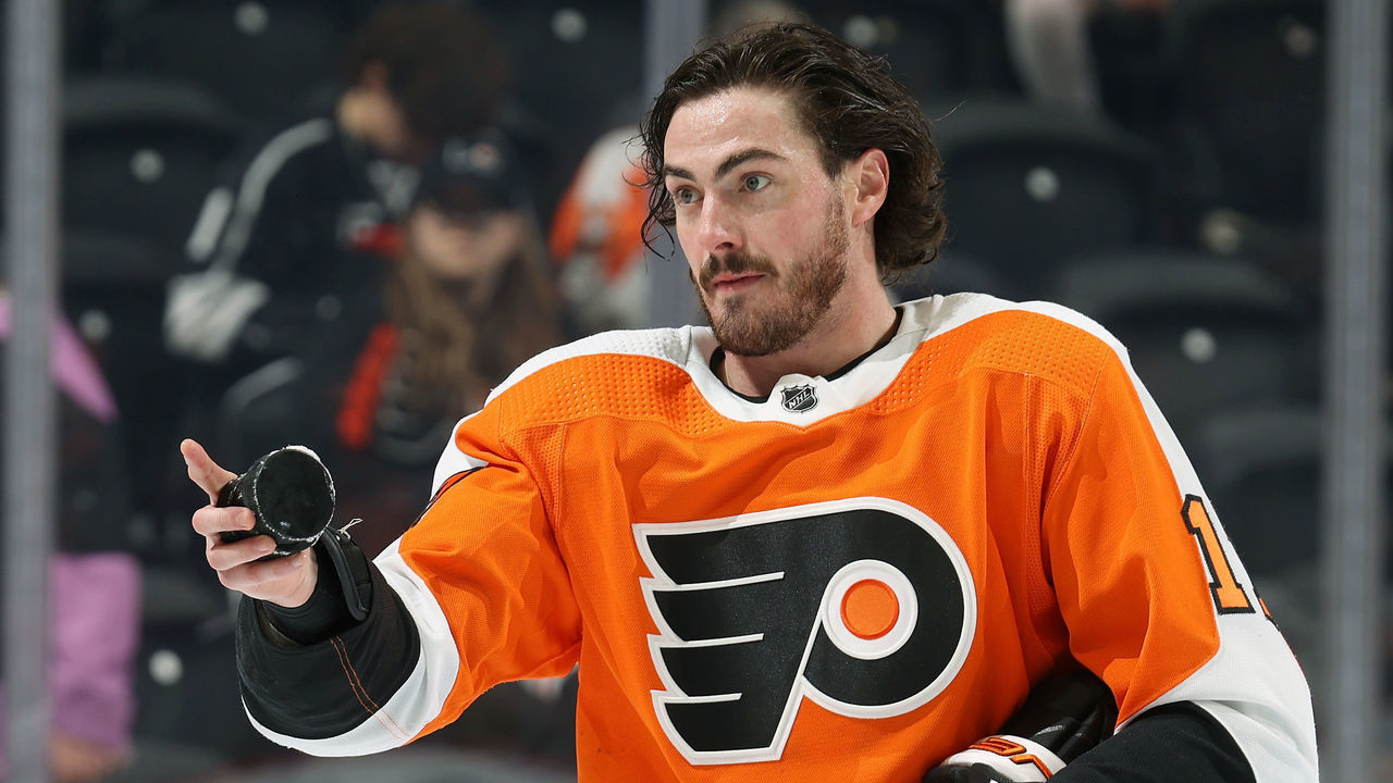 PHILADELPHIA, PENNSYLVANIA - JANUARY 24: Zack MacEwen #17 of the Philadelphia Flyers looks to toss a puck into the crowd during warm-ups prior to his game against the Los Angeles Kings at the Wells Fargo Center on January 24, 2023 in Philadelphia, Pennsylvania.