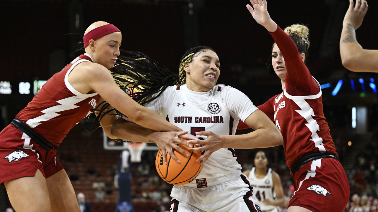GREENVILLE, SOUTH CAROLINA - MARCH 03: Victaria Saxton #5 of the South Carolina Gamecocks wrestles for the ball with Rylee Langerman #11 and Saylor Poffenbarger #0 of the Arkansas Razorbacks in the third quarter during the quarterfinals of the SEC Women's Basketball Tournament at Bon Secours Wellness Arena on March 03, 2023 in Greenville, South Carolina.