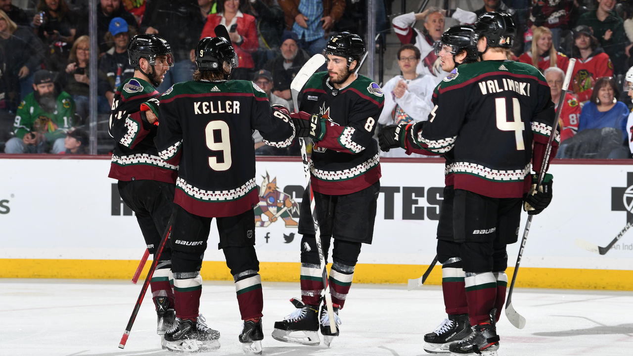 TEMPE, ARIZONA - FEBRUARY 28: Nick Schmaltz #8 of the Arizona Coyotes celebrates with Shayne Gostisbehere #14, Clayton Keller #9 and teammates after scoring a goal against the Chicago Blackhawks during the third period at Mullett Arena on February 28, 2023 in Tempe, Arizona.