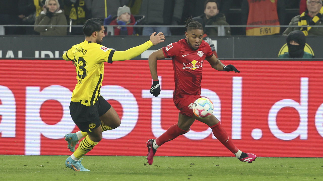 DORTMUND, GERMANY - MARCH 03: Emre Can of Borussia Dortmund and Christopher Nkunku of RB Leipzig battle for the Ball during the Bundesliga match between Borussia Dortmund and RB Leipzig at Signal Iduna Park on March 3, 2023 in Dortmund, Germany.