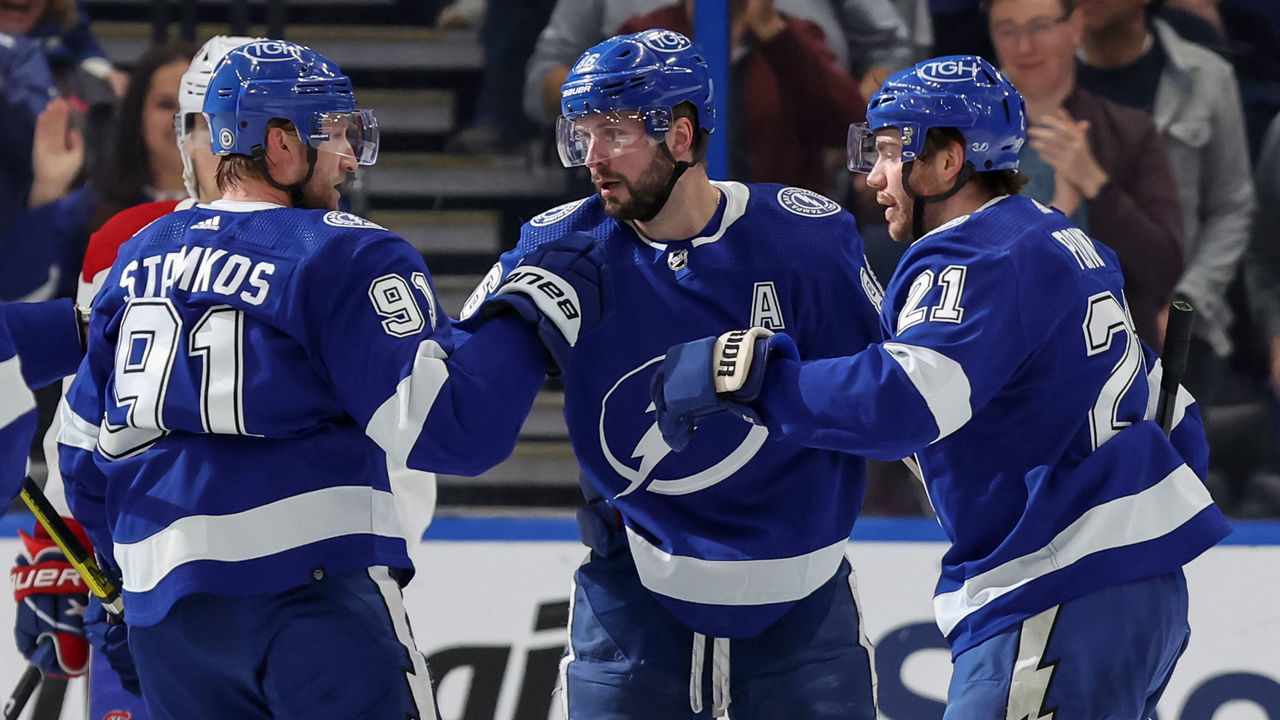 TAMPA, FL - DECEMBER 28: Steven Stamkos #91, Nikita Kucherov #86, and Brayden Point #21 of the Tampa Bay Lightning celebrate a goal against the Montreal Canadiens during the game at the Amalie Arena on December 28, 2022 in Tampa, Florida.