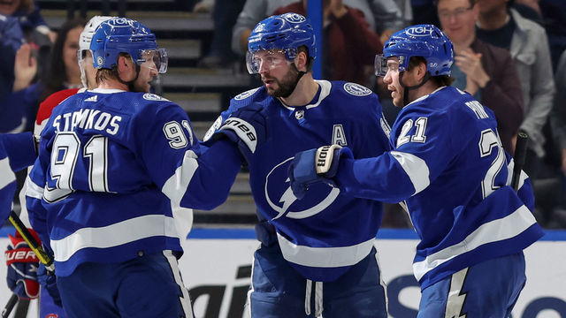 TAMPA, FL - DECEMBER 28: Steven Stamkos #91, Nikita Kucherov #86, and Brayden Point #21 of the Tampa Bay Lightning celebrate a goal against the Montreal Canadiens during the game at the Amalie Arena on December 28, 2022 in Tampa, Florida.