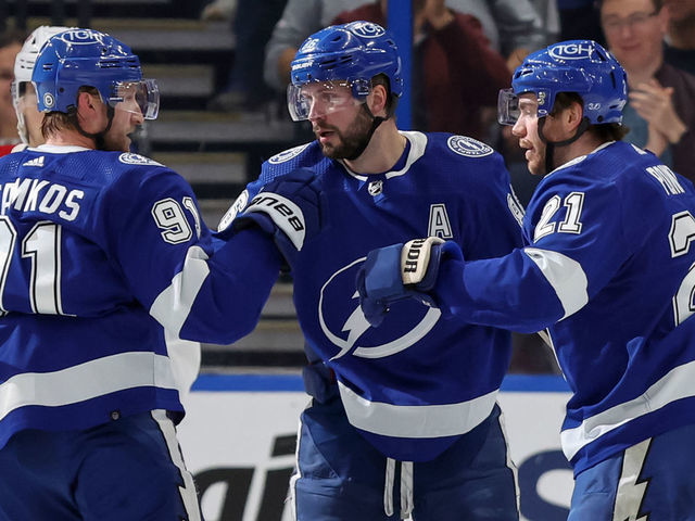 TAMPA, FL - DECEMBER 28: Steven Stamkos #91, Nikita Kucherov #86, and Brayden Point #21 of the Tampa Bay Lightning celebrate a goal against the Montreal Canadiens during the game at the Amalie Arena on December 28, 2022 in Tampa, Florida.