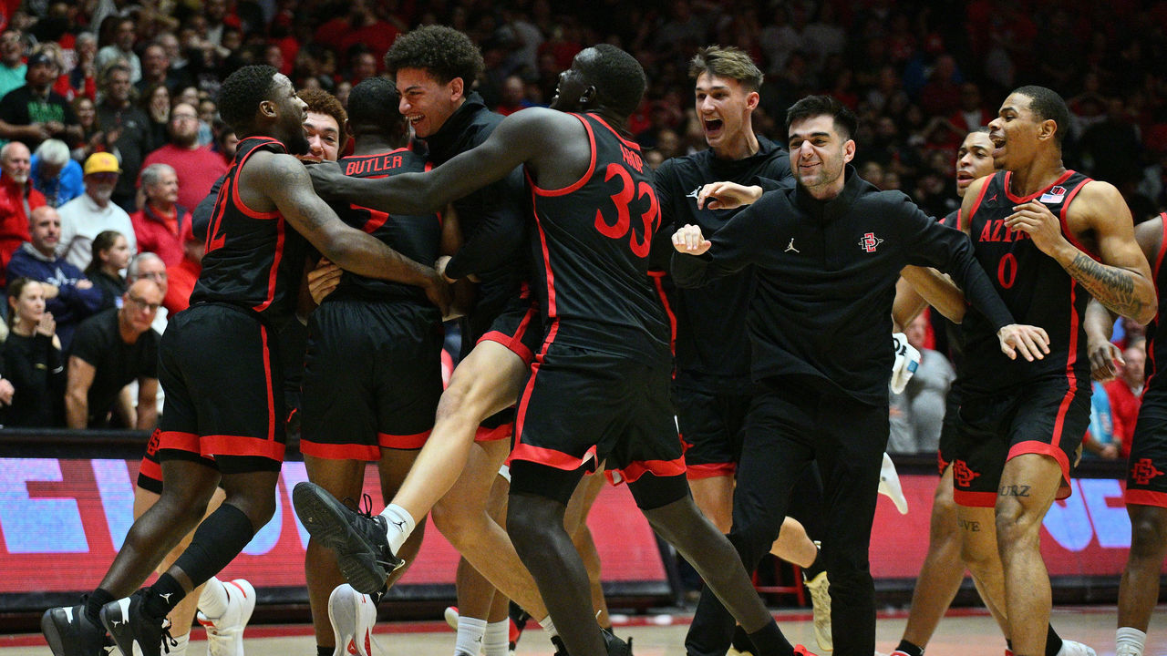 ALBUQUERQUE, NEW MEXICO - FEBRUARY 25: The San Diego State Aztecs celebrate after Lamont Butler (2L) #5 hit the game-winning 3-pointer during the second half of their game at The Pit on February 25, 2023 in Albuquerque, New Mexico. The Aztecs defeated the Lobos 73-71.