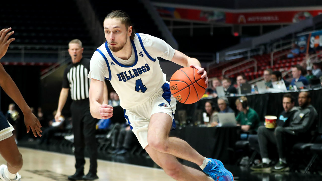 CHARLOTTE, NC - MARCH 03: Drew Pember (4) of the North Carolina-Asheville Bulldogs drives to the basket during the Big South Tournament against the Charleston Southern Buccaneers on March 3, 2023 at Bojangles Coliseum in Charlotte, NC.