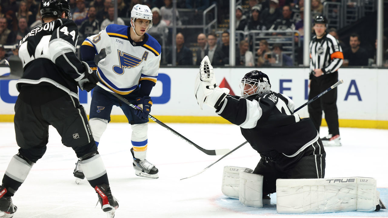 LOS ANGELES, CALIFORNIA - MARCH 04: Joonas Korpisalo #70 of the Los Angeles Kings makes a save in front of Brayden Schenn #10 of the St. Louis Blues and Mikey Anderson #44 during a 4-2 Kings win at Crypto.com Arena on March 04, 2023 in Los Angeles, California.