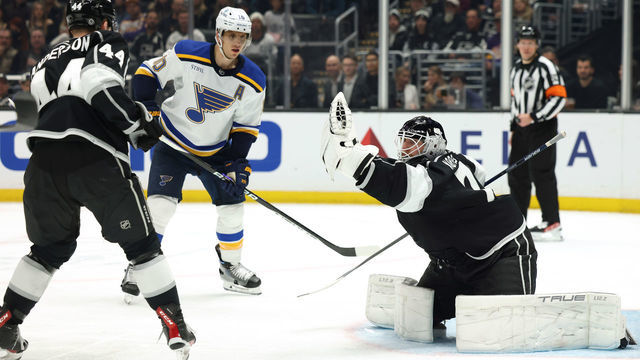 LOS ANGELES, CALIFORNIA - MARCH 04: Joonas Korpisalo #70 of the Los Angeles Kings makes a save in front of Brayden Schenn #10 of the St. Louis Blues and Mikey Anderson #44 during a 4-2 Kings win at Crypto.com Arena on March 04, 2023 in Los Angeles, California.