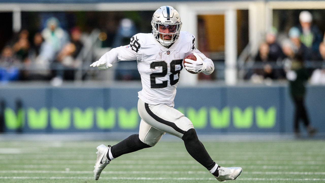 SEATTLE, WASHINGTON - NOVEMBER 27: Josh Jacobs #28 of the Las Vegas Raiders carries the ball during the second quarter of the game against the Seattle Seahawks at Lumen Field on November 27, 2022 in Seattle, Washington.