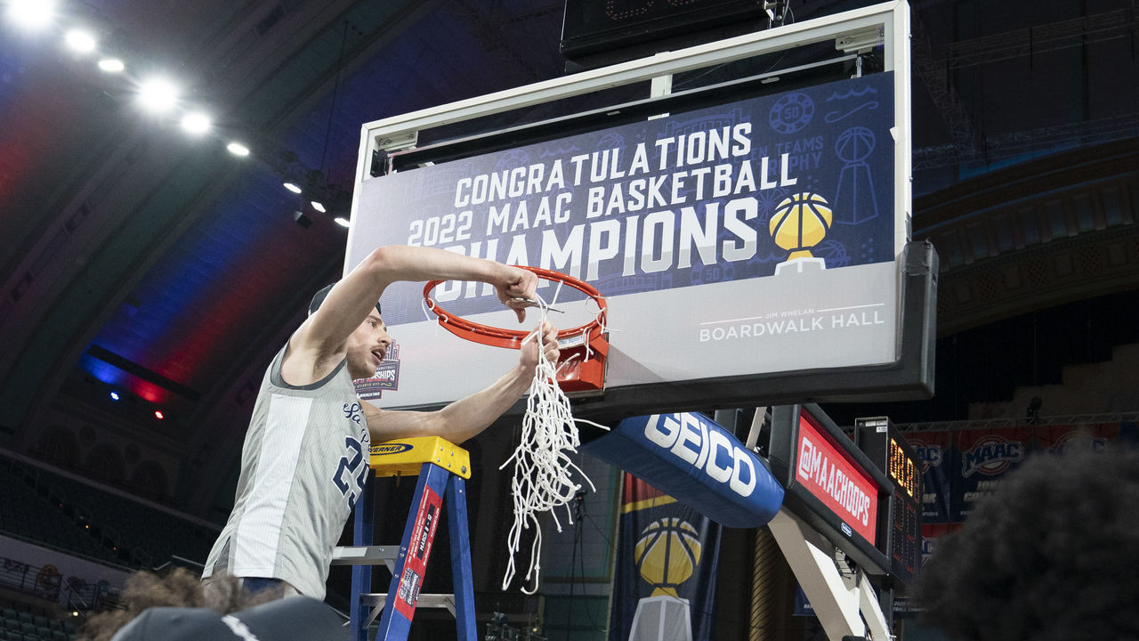 ATLANTIC CITY, NJ - MARCH 12: St. Peter's Peacocks Guard Doug Edert (25) cuts down the net during the second half of the MAAC Conference Basketball Tournament final game between the Monmouth Hawks and the St. Peters Peacocks on March 12, 2022 at the Boardwalk Hall in Atlantic City, NJ.