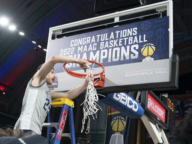 ATLANTIC CITY, NJ - MARCH 12: St. Peter's Peacocks Guard Doug Edert (25) cuts down the net during the second half of the MAAC Conference Basketball Tournament final game between the Monmouth Hawks and the St. Peters Peacocks on March 12, 2022 at the Boardwalk Hall in Atlantic City, NJ.