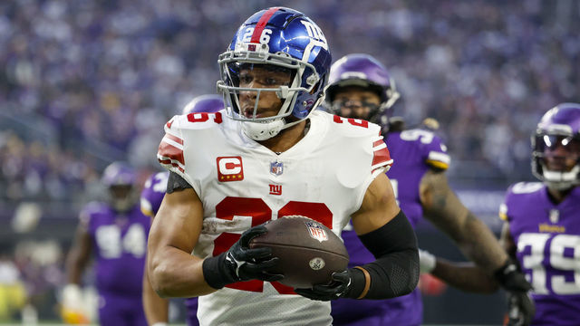 MINNEAPOLIS, MINNESOTA - JANUARY 15: Saquon Barkley #26 of the New York Giants rushes for a touchdown during the first quarter against the Minnesota Vikings in the NFC Wild Card playoff game at U.S. Bank Stadium on January 15, 2023 in Minneapolis, Minnesota.