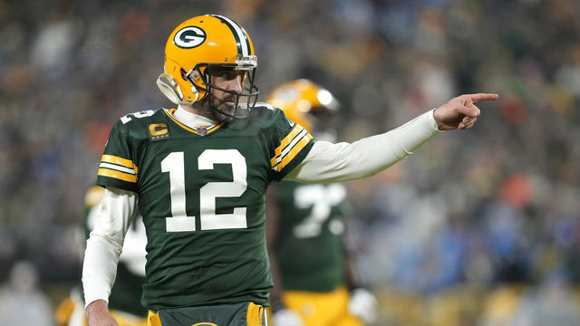 GREEN BAY, WISCONSIN - JANUARY 08: Aaron Rodgers #12 of the Green Bay Packers reacts after throwing a touchdown pass during the third quarter against the Detroit Lions at Lambeau Field on January 08, 2023 in Green Bay, Wisconsin.