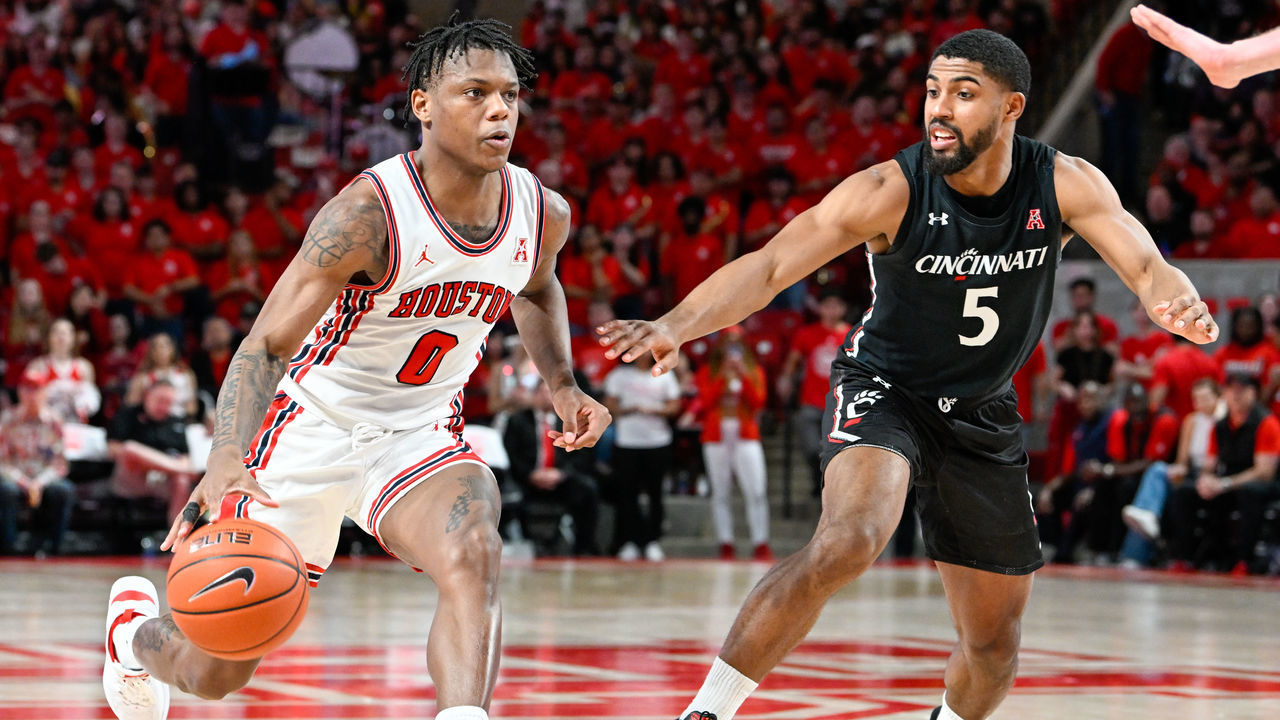 HOUSTON, TX - JANUARY 28: Houston Cougars guard Marcus Sasser (0) drives hard on Cincinnati Bearcats guard David DeJulius (5) during the basketball game between the Cincinnati Bearcats and Houston Cougars at the Fertitta Center on January 28, 2023 in Houston, Texas.