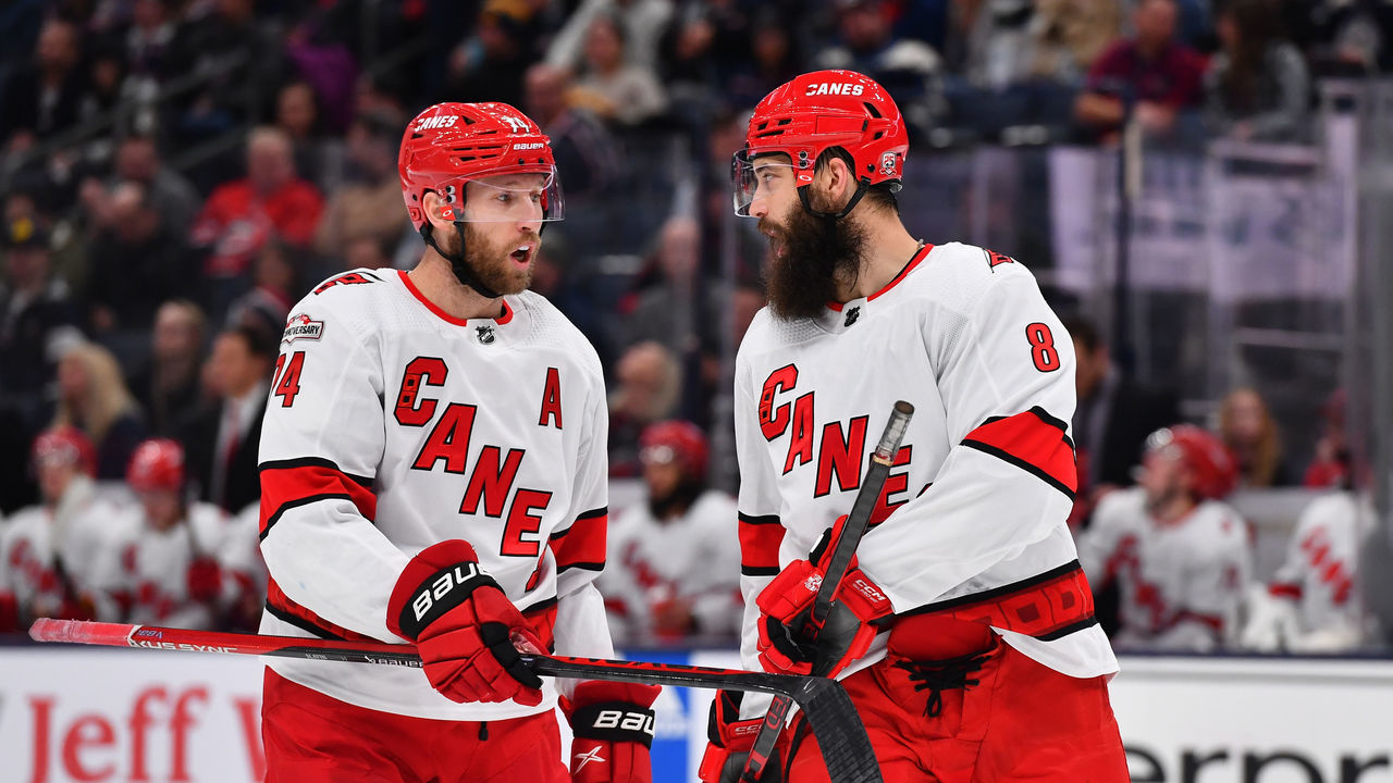 COLUMBUS, OHIO - JANUARY 12: Teammates Jaccob Slavin #74 and Brent Burns #8 of the Carolina Hurricanes talk during the first period of a game against the Columbus Blue Jackets at Nationwide Arena on January 12, 2023 in Columbus, Ohio.
