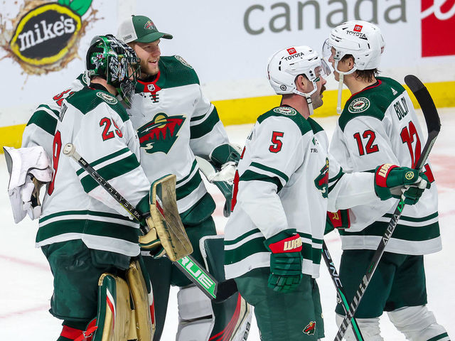 WINNIPEG, CANADA - MARCH 8: Goaltender Marc-Andre Fleury #29 of the Minnesota Wild gets congratulated by teammates Filip Gustavsson #32, Jake Middleton #5 and Matt Boldy #12 following a 4-2 victory over the Winnipeg Jets at the Canada Life Centre on March 8, 2023 in Winnipeg, Manitoba, Canada.
