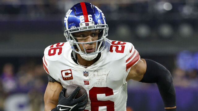 MINNEAPOLIS, MINNESOTA - JANUARY 15: Saquon Barkley #26 of the New York Giants rushes during the fourth quarter against the Minnesota Vikings in the NFC Wild Card playoff game at U.S. Bank Stadium on January 15, 2023 in Minneapolis, Minnesota.