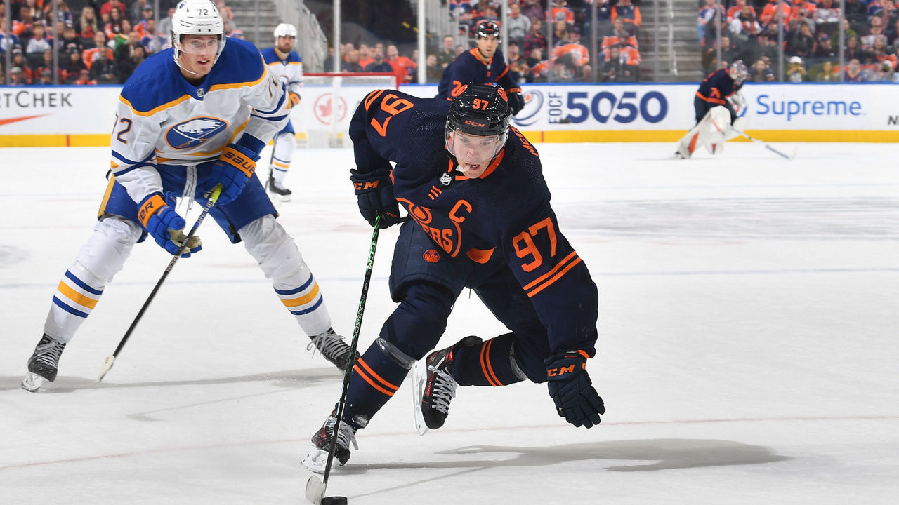 EDMONTON, CANADA - OCTOBER 18: Connor McDavid #97 of the Edmonton Oilers skates with the puck while being pursued by Tage Thompson #72 of the Buffalo Sabres on October 18, 2022 at Rogers Place in Edmonton, Alberta, Canada.