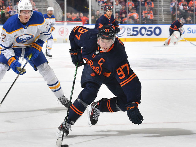 EDMONTON, CANADA - OCTOBER 18: Connor McDavid #97 of the Edmonton Oilers skates with the puck while being pursued by Tage Thompson #72 of the Buffalo Sabres on October 18, 2022 at Rogers Place in Edmonton, Alberta, Canada.