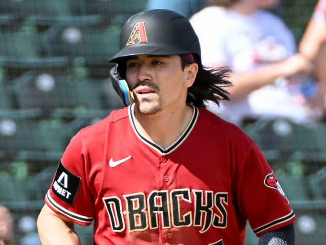 MESA, ARIZONA - FEBRUARY 25, 2023: Corbin Carroll #7 of the Arizona Diamondbacks takes a lead at third base during the first inning of a spring training game against the Oakland Athletics at Hohokam Stadium on February 25, 2023 in Mesa, Arizona.