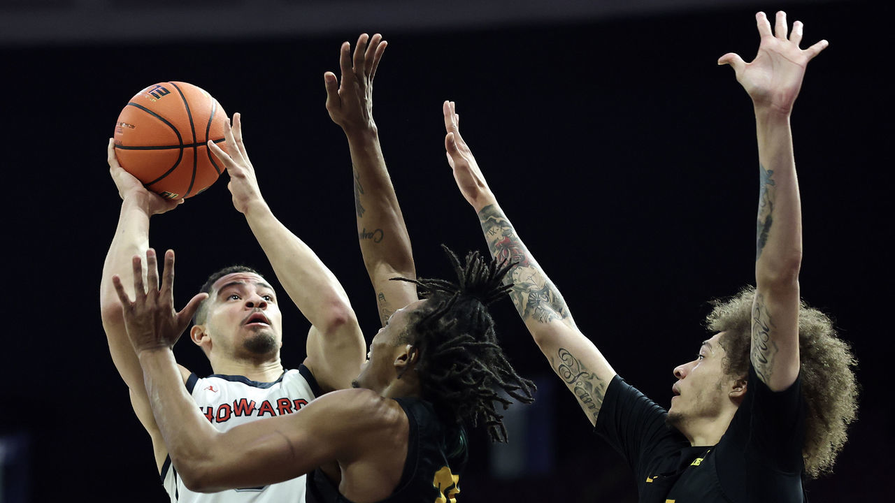 NORFOLK, VIRGINIA - MARCH 11: Jelani Williams #5 of the Howard Bison shoots over Cahiem Brown #31 and Tyrese Jenkins #5 of the Norfolk State Spartans during the first half during the 2023 MEAC Men's Basketball Tournament Championship at Norfolk Scope Arena on March 11, 2023 in Norfolk, Virginia.