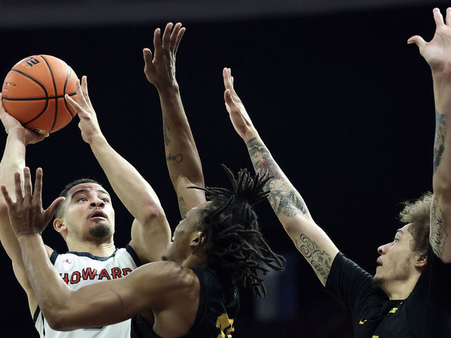 NORFOLK, VIRGINIA - MARCH 11: Jelani Williams #5 of the Howard Bison shoots over Cahiem Brown #31 and Tyrese Jenkins #5 of the Norfolk State Spartans during the first half during the 2023 MEAC Men's Basketball Tournament Championship at Norfolk Scope Arena on March 11, 2023 in Norfolk, Virginia.