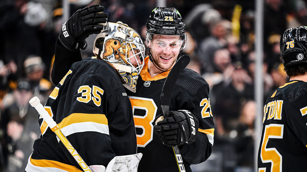 BOSTON, MASSACHUSETTS - MARCH 11: Brandon Carlo #25 of the Boston Bruins celebrates a win against the Detroit Red Wings with Linus Ullmark #35 at TD Garden on March 11, 2023 in Boston, Massachusetts.