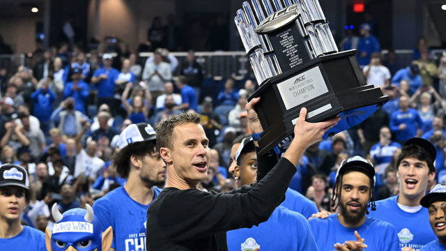 GREENSBORO, NORTH CAROLINA - MARCH 11: Head coach Jon Scheyer and the Duke Blue Devils hoist the trophy after a win against the Virginia Cavaliers in the ACC Basketball Tournament Championship game at Greensboro Coliseum on March 11, 2023 in Greensboro, North Carolina. Duke won 59-49.