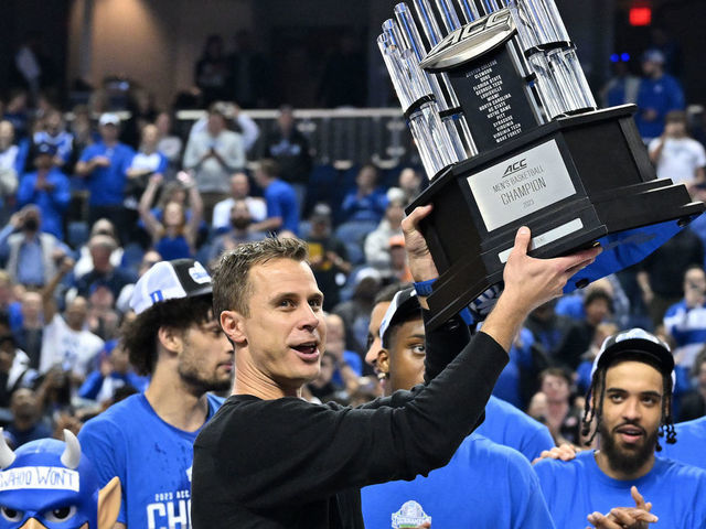 GREENSBORO, NORTH CAROLINA - MARCH 11: Head coach Jon Scheyer and the Duke Blue Devils hoist the trophy after a win against the Virginia Cavaliers in the ACC Basketball Tournament Championship game at Greensboro Coliseum on March 11, 2023 in Greensboro, North Carolina. Duke won 59-49.