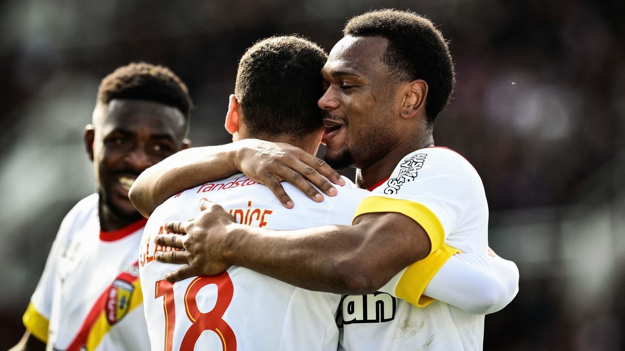 Lens French forward Alexis Claude Maurice (C) celebrates with Lens Belgian forward Lois Openda (R) after scoring a fourth goal for his team during the French L1 football match between Clermont Foot 63 and RC Lens at Stade Gabriel Montpied in Clermont-Ferrand, central France on March 12, 2023.