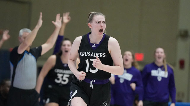 WASHINGTON, DC - JANUARY 05: Bronagh Power-Cassidy #13 of the Holy Cross Crusaders celebrates a shot during a womens college basketball game against the American Eagles at Bender Arena on January 5, 2023 in Washington, DC.