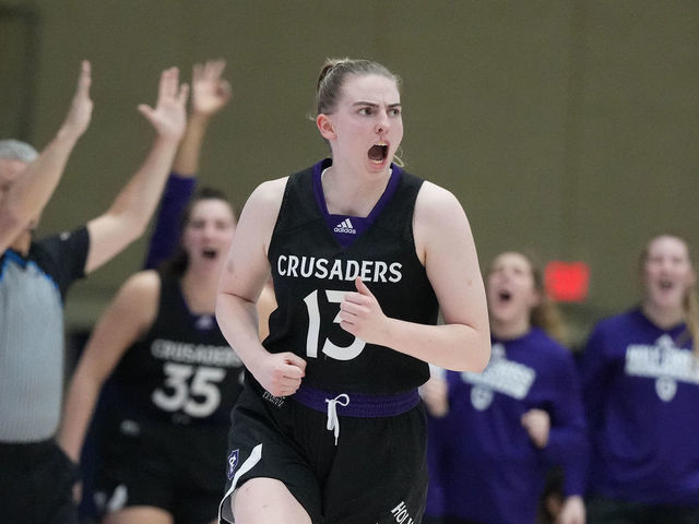 WASHINGTON, DC - JANUARY 05: Bronagh Power-Cassidy #13 of the Holy Cross Crusaders celebrates a shot during a womens college basketball game against the American Eagles at Bender Arena on January 5, 2023 in Washington, DC.