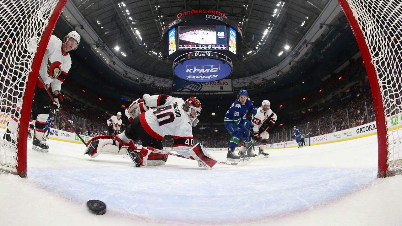 VANCOUVER, CANADA - MARCH 11: Andrei Kuzmenko #96 of the Vancouver Canucks scores on Mads Sogaard #40 of the Ottawa Senators during the second period their NHL game at Rogers Arena March 11, 2023 in Vancouver, British Columbia, Canada.