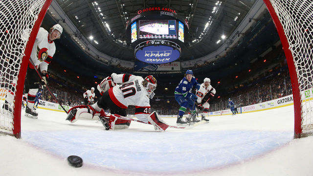 VANCOUVER, CANADA - MARCH 11: Andrei Kuzmenko #96 of the Vancouver Canucks scores on Mads Sogaard #40 of the Ottawa Senators during the second period their NHL game at Rogers Arena March 11, 2023 in Vancouver, British Columbia, Canada.