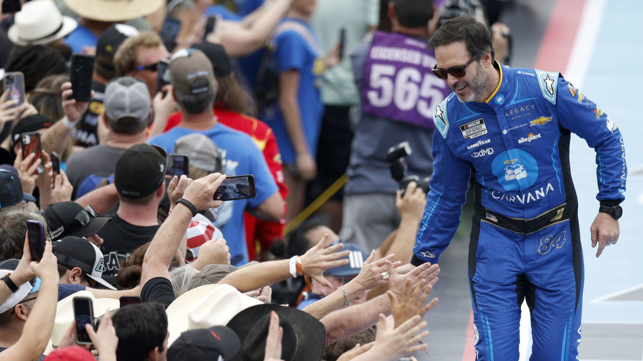 DAYTONA BEACH, FLORIDA - FEBRUARY 19: Jimmie Johnson, driver of the #84 Carvana Chevrolet, greets fans onstage during driver intros prior to the NASCAR Cup Series 65th Annual Daytona 500 at Daytona International Speedway on February 19, 2023 in Daytona Beach, Florida.