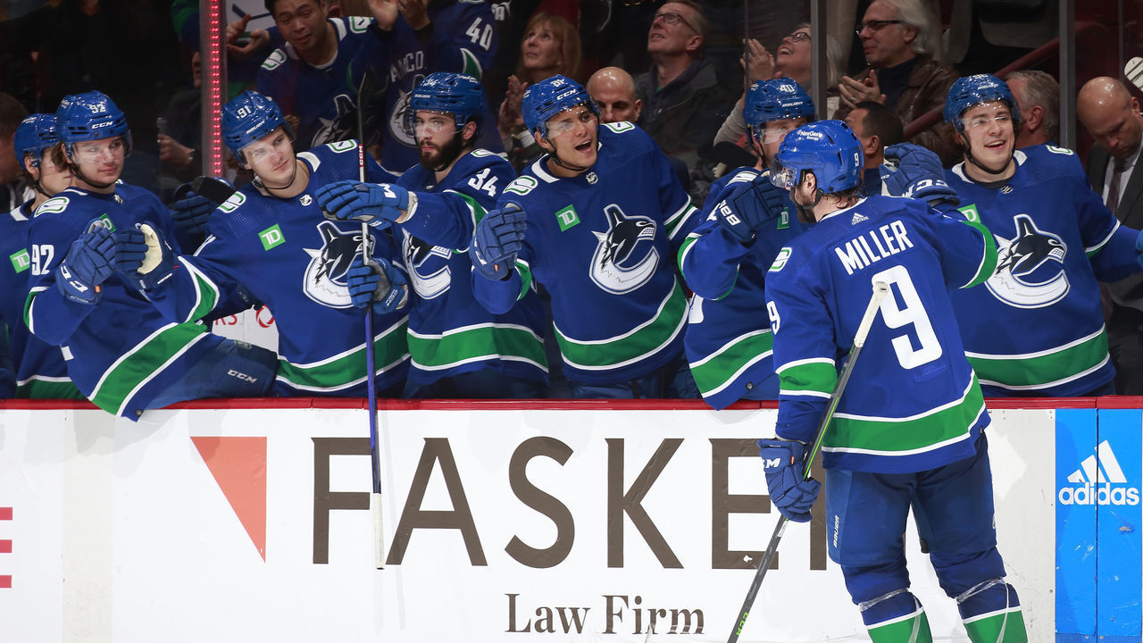 VANCOUVER, CANADA - MARCH 11: J.T. Miller #9 of the Vancouver Canucks is congratulated by teammates after scoring during the second period of their NHL game against the Ottawa Senators at Rogers Arena March 11, 2023 in Vancouver, British Columbia, Canada.