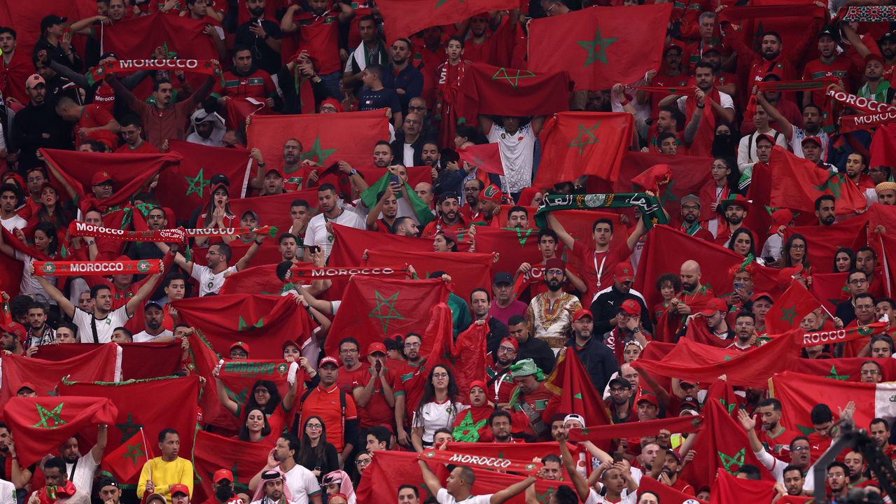 AL KHOR, QATAR - DECEMBER 14: Morocco fans hold up their country's flag during the FIFA World Cup Qatar 2022 semi final match between France and Morocco at Al Bayt Stadium on December 14, 2022 in Al Khor, Qatar.
