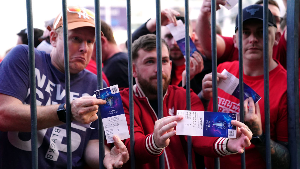 Liverpool fans stuck outside the ground show their match tickets during the UEFA Champions League Final at the Stade de France, Paris. Picture date: Saturday May 28, 2022.