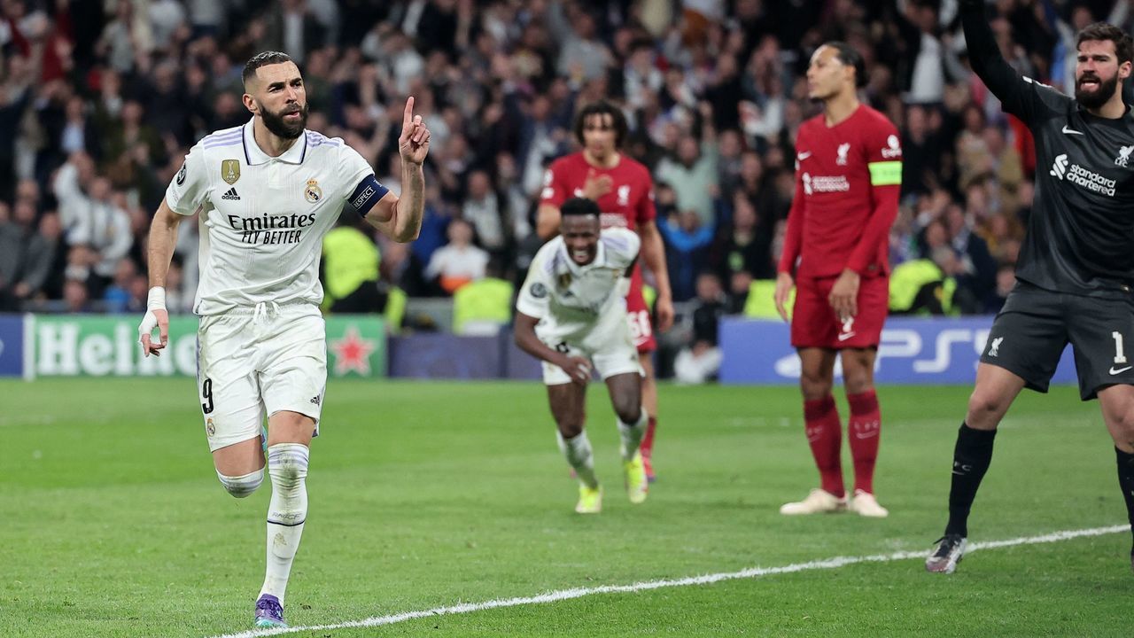 Real Madrid's French forward Karim Benzema (L) celebrates scoring his team's first goal during the UEFA Champions League last 16 second leg football match between Real Madrid CF and Liverpool FC at the Santiago Bernabeu stadium in Madrid on March 15, 2023.