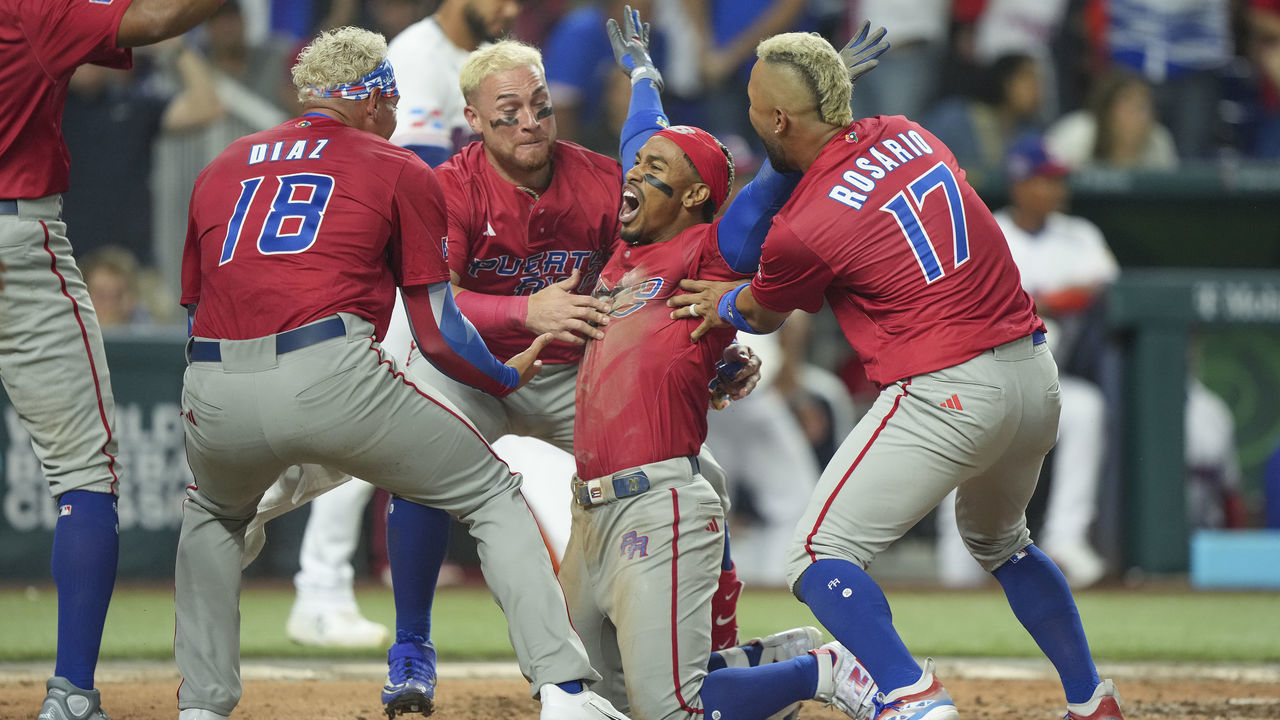 MIAMI, FLORIDA - MARCH 15: Francisco Lindor #12 of Puerto Rico celebrates with teammates after he scored during the fifth inning of the World Baseball Classic Pool D game against the Dominican Republic at loanDepot park on March 15, 2023 in Miami, Florida.