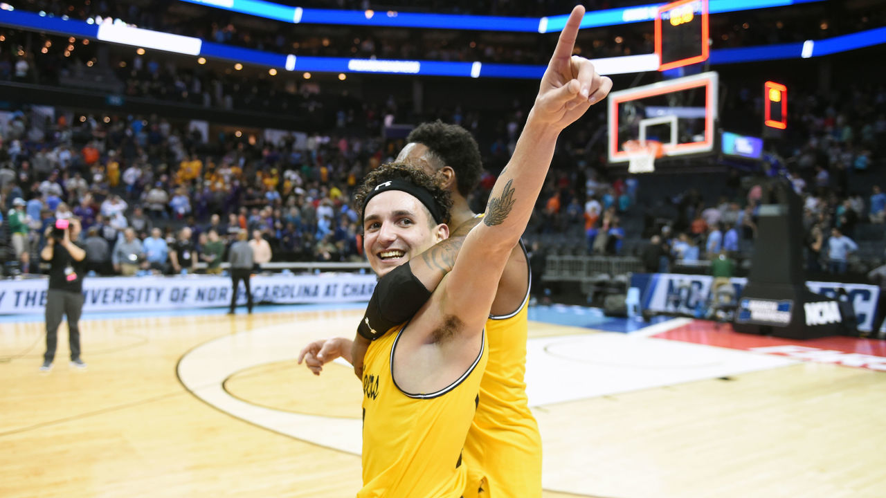 CHARLOTTE, NC - MARCH 16: K.J. Maura #11 of the UMBC Retrievers celebrates a win after the first round of the 2018 NCAA Men's Basketball Tournament against the Virginia Cavaliers at the Spectrum Center on March 16, 2018 in Charlotte, North Carolina. The Retrievers won 74-54. Photo by Mitchell Layton/Getty Images) *** Local Caption *** K.J. Macura