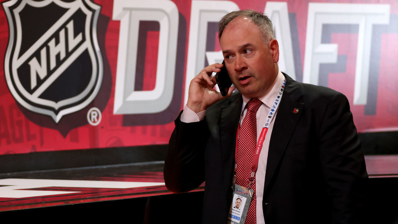 MONTREAL, QUEBEC - JULY 08: General manager Pierre Dorion of the Ottawa Senators talks on his phone during the 2022 Upper Deck NHL Draft at Bell Centre on July 08, 2022 in Montreal, Quebec.