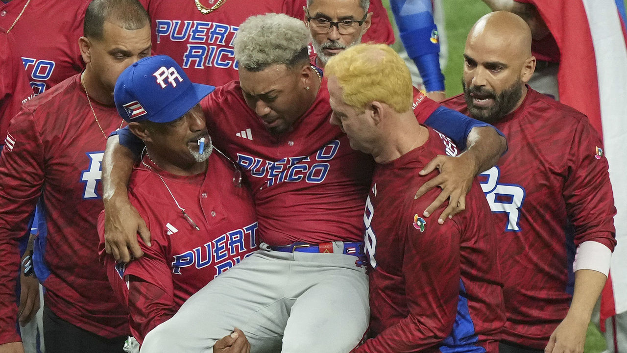 MIAMI, FLORIDA - MARCH 15: Edwin Diaz #39 of Puerto Rico is helped off the field after being injured during the on-field celebration after defeating the Dominican Republic during the World Baseball Classic Pool D at loanDepot park on March 15, 2023 in Miami, Florida.