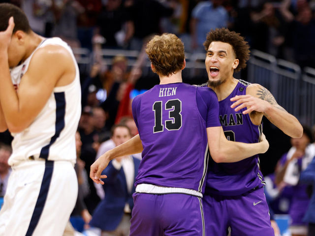 ORLANDO, FL - MARCH 16: Garrett Hien #13 and Jalen Slawson #20 of the Furman Paladins celebrate near the end of their game against the Virginia Cavaliers in the first round of the NCAA Men's Basketball Tournament at Amway Center on March 16, 2023 in Orlando, Florida. Furman won 68-76.