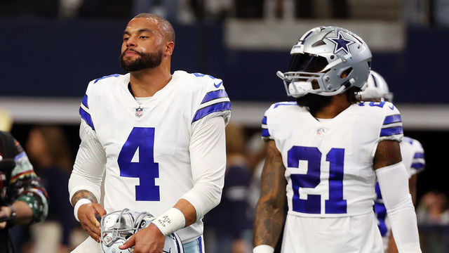 ARLINGTON, TEXAS - DECEMBER 24: Dak Prescott #4 and Ezekiel Elliott #21 of the Dallas Cowboys walk on the field during warmups at AT&T Stadium on December 24, 2022 in Arlington, Texas.