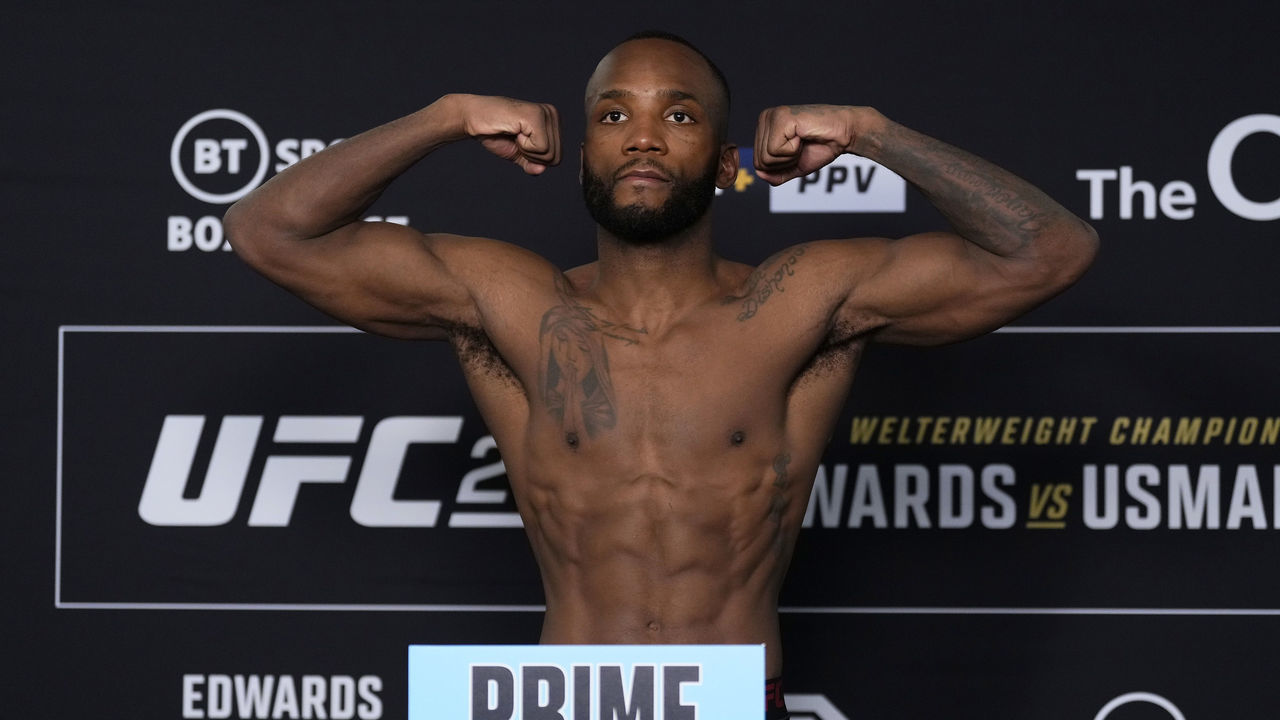 LONDON, ENGLAND - MARCH 17: Leon Edwards of Jamaica poses on the scale during the UFC 286 official weigh-in at Hilton London Canary Wharf on March 17, 2023 in London, England.